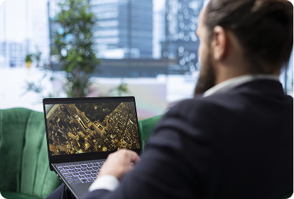 Businessperson on a green couch analyzing cityscape data on a laptop